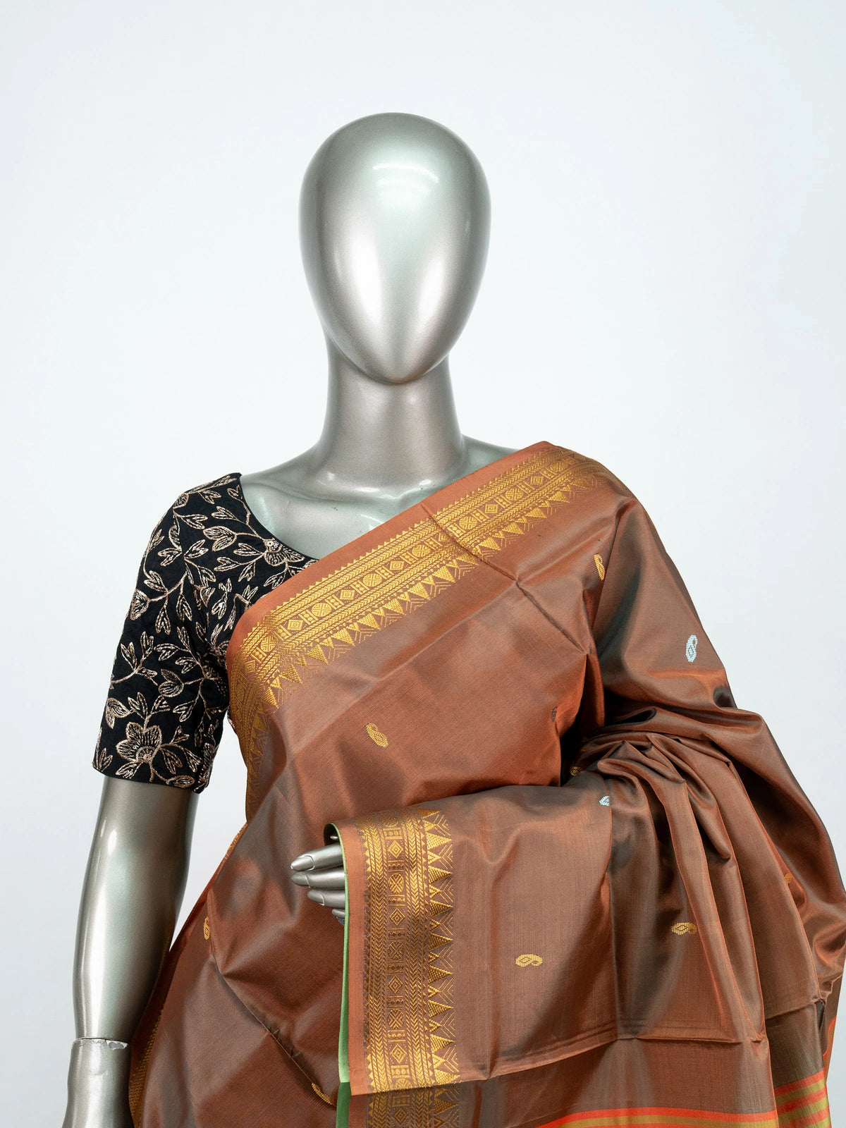 Brown banana silk saree with gold zari border and contrast green striped pallu