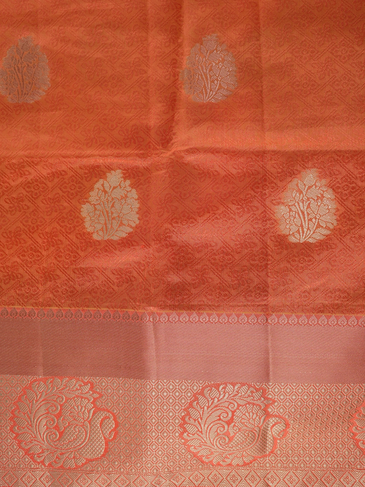 Orange semi tussar saree with gold zari floral buttas and ornate contrast zari border