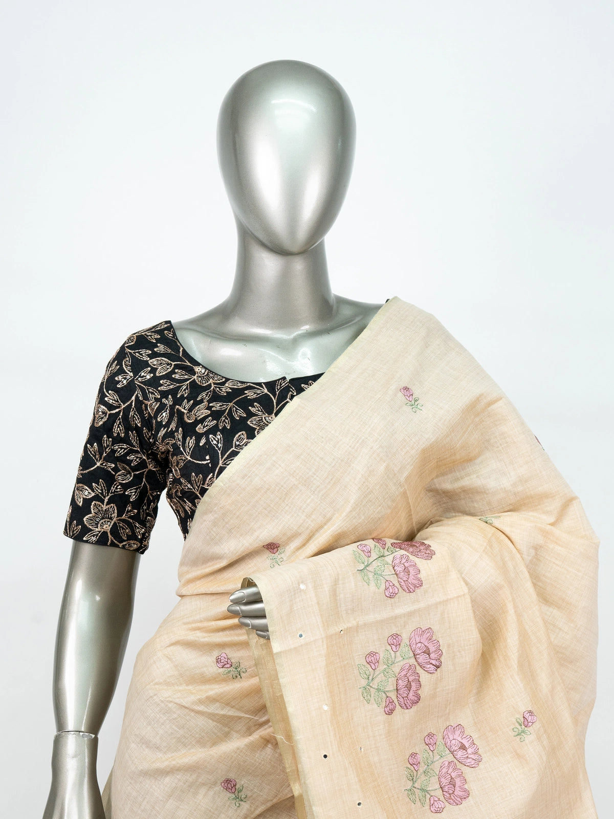 Cream linen cotton saree with mauve floral embroidery, fine zari border and tasseled pallu