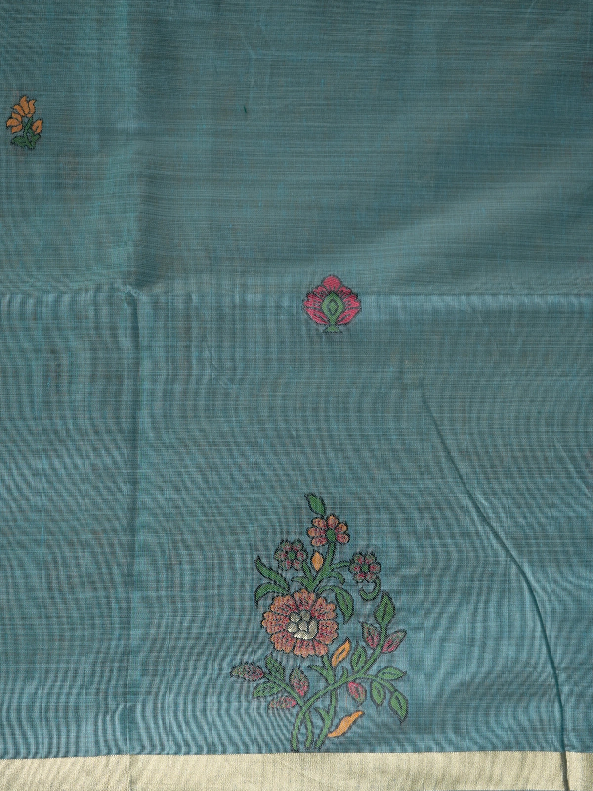 Teal blue linen cotton saree with floral butta body, gold zari border and parrot motif pallu