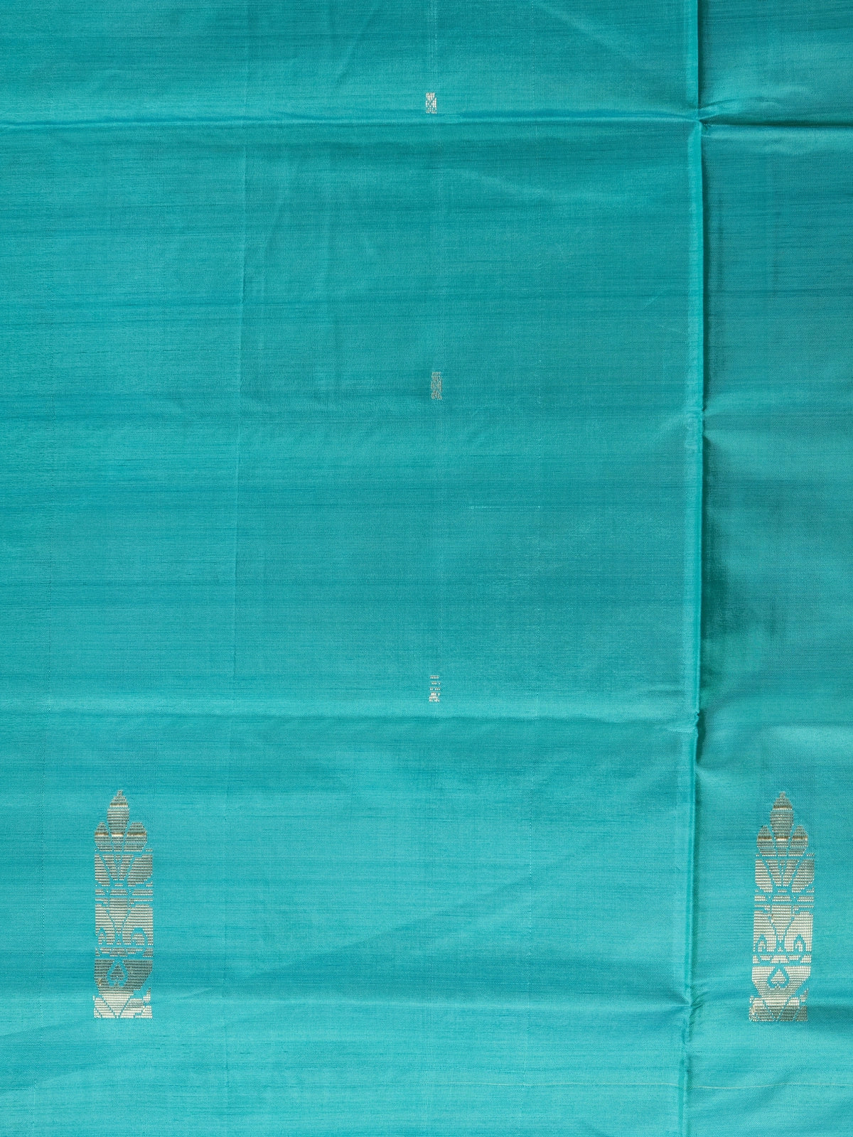 Teal banana silk saree with yellow contrast pallu, silver zari buttas, and matching yellow blouse