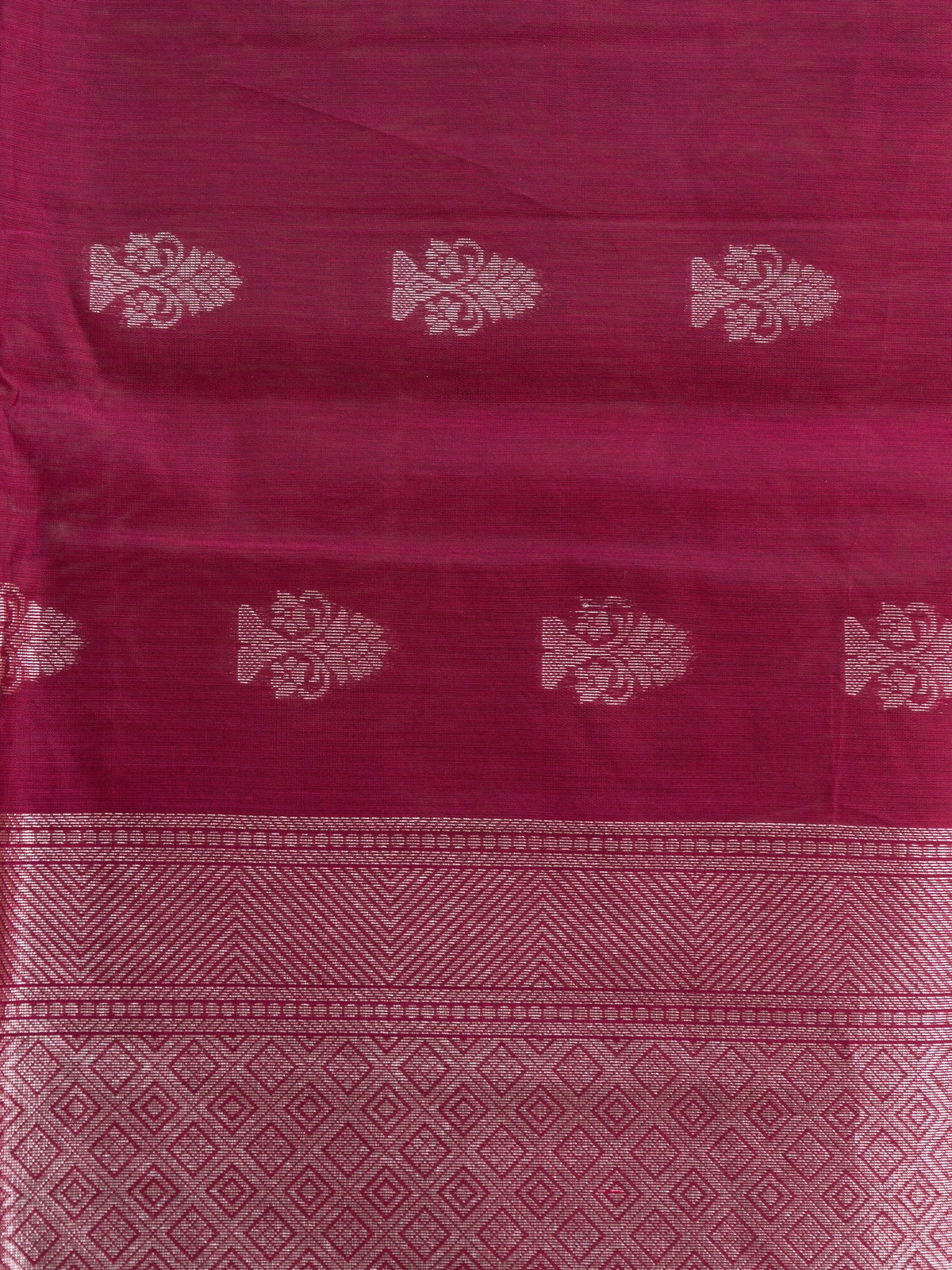 Magenta silk cotton saree with silver zari floral buttis and woven border