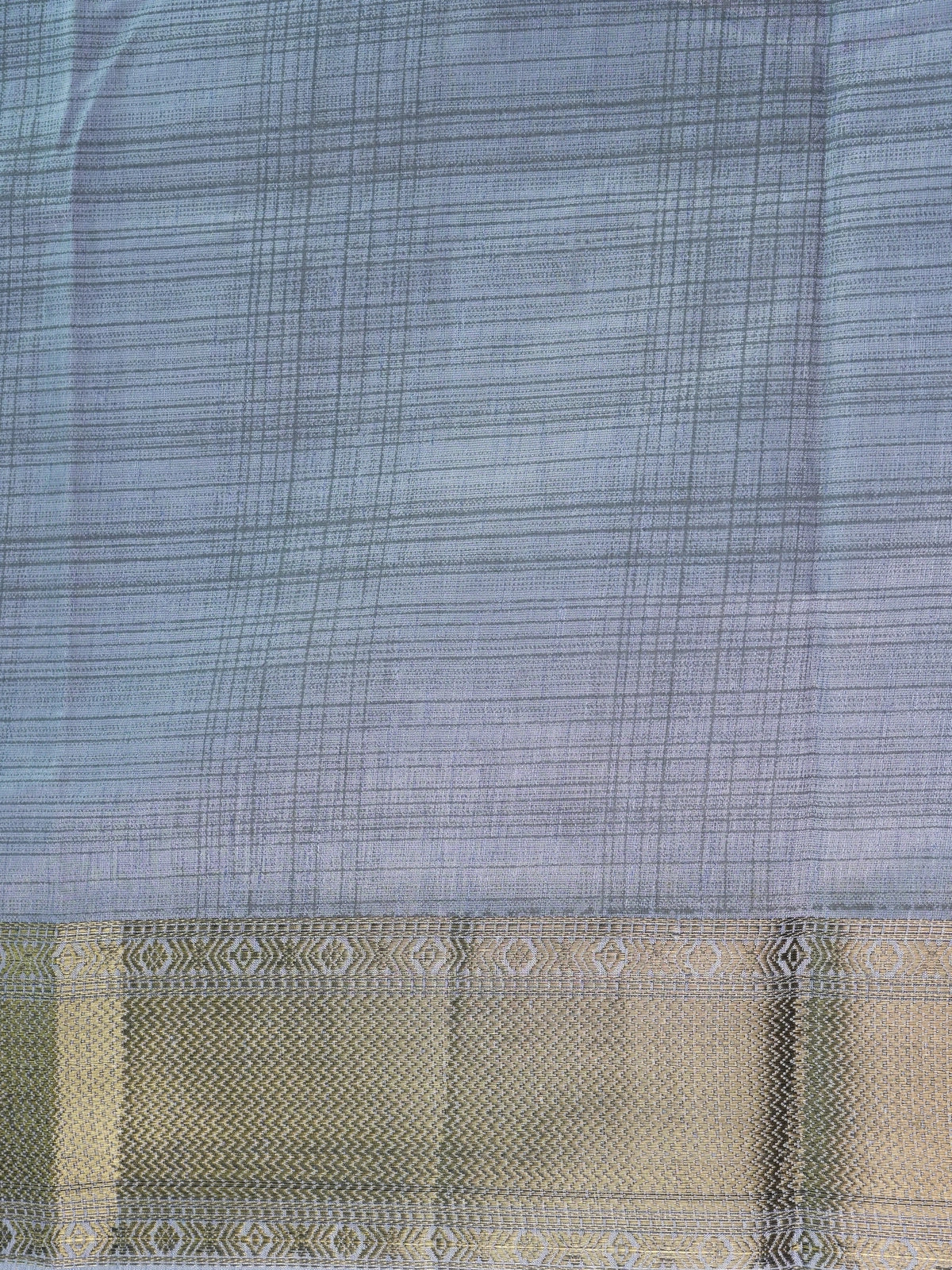 Grey semi tussar saree with crosshatch weave and gold zari border