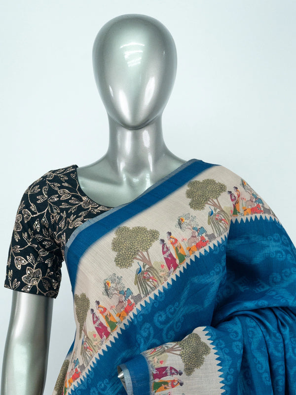 Peacock blue linen cotton saree with cream folk-art border and pallu featuring trees, figures and peacocks