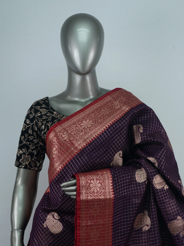 Deep purple semi raw silk saree with zari checks, gold paisley motifs and a contrast red zari border