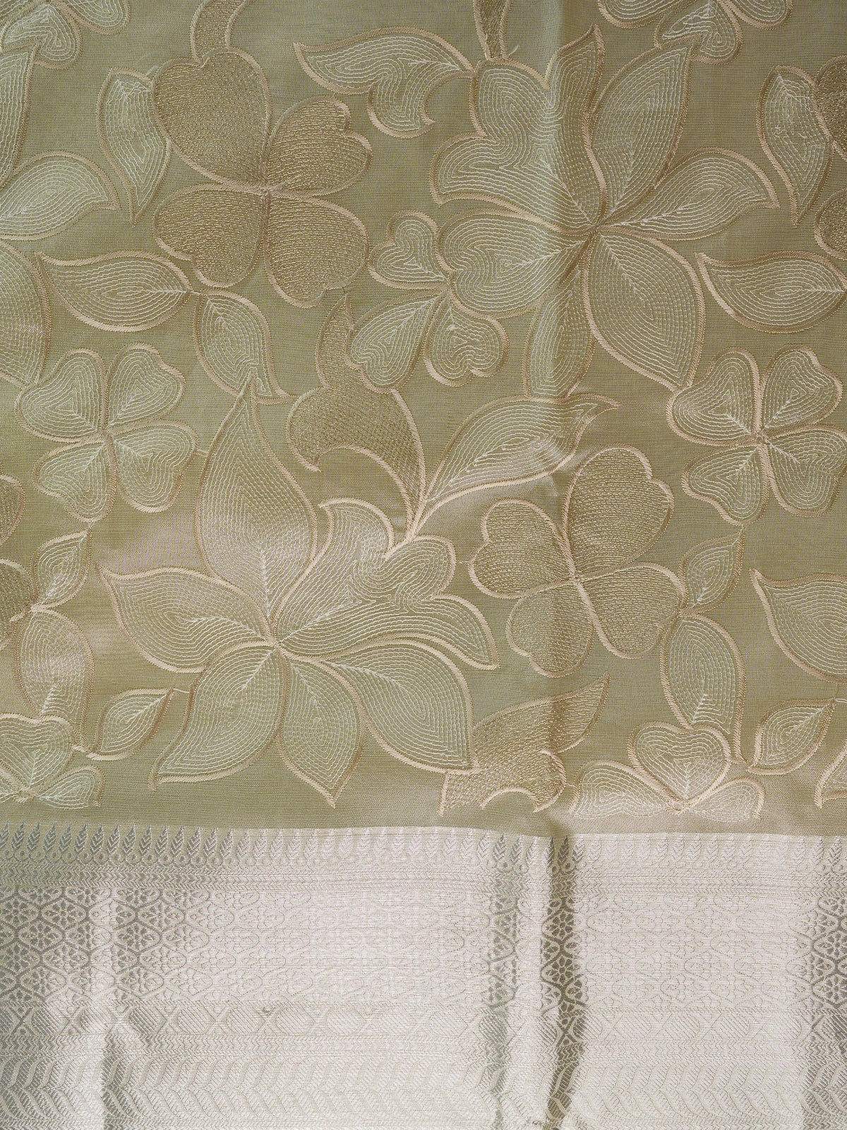 Cream tissue designer saree with floral embroidery and silver zari border