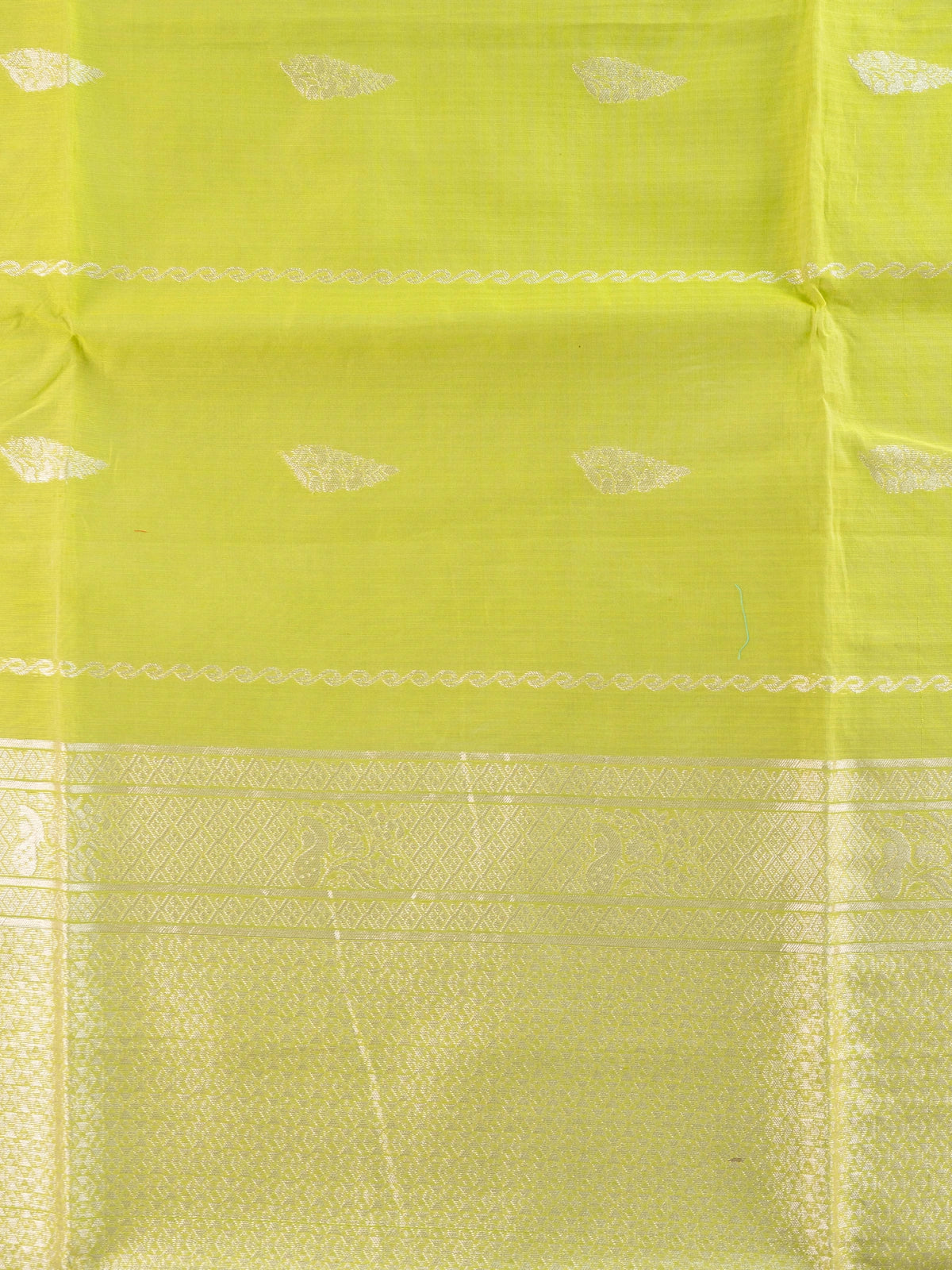 Lime green silk cotton saree with silver zari border and buttas
