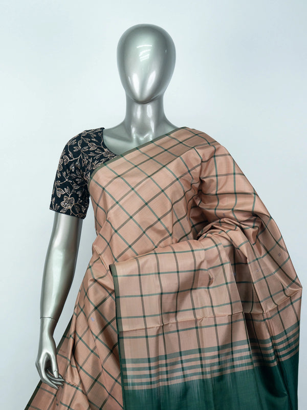 Dusty peach and green checked banana silk saree with green zari pallu and contrast border