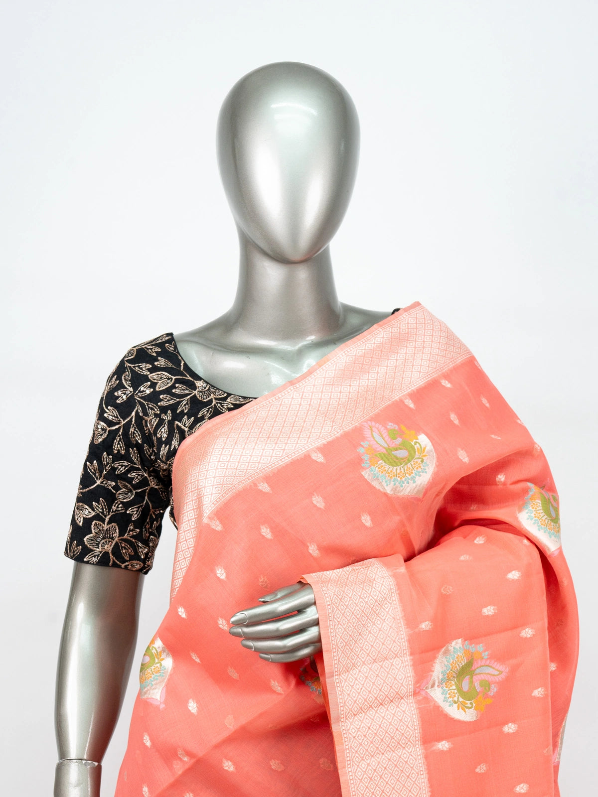Peach linen cotton saree with silver zari border, peacock motifs and floral zari pallu