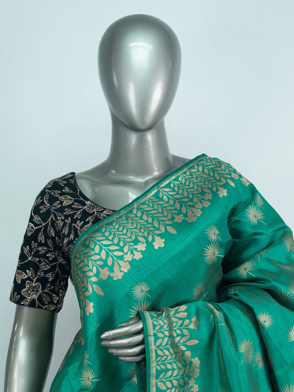 Sea green semi raw silk saree with gold zari floral motifs, woven leaf border and a multicolour floral pallu with contrast black blouse