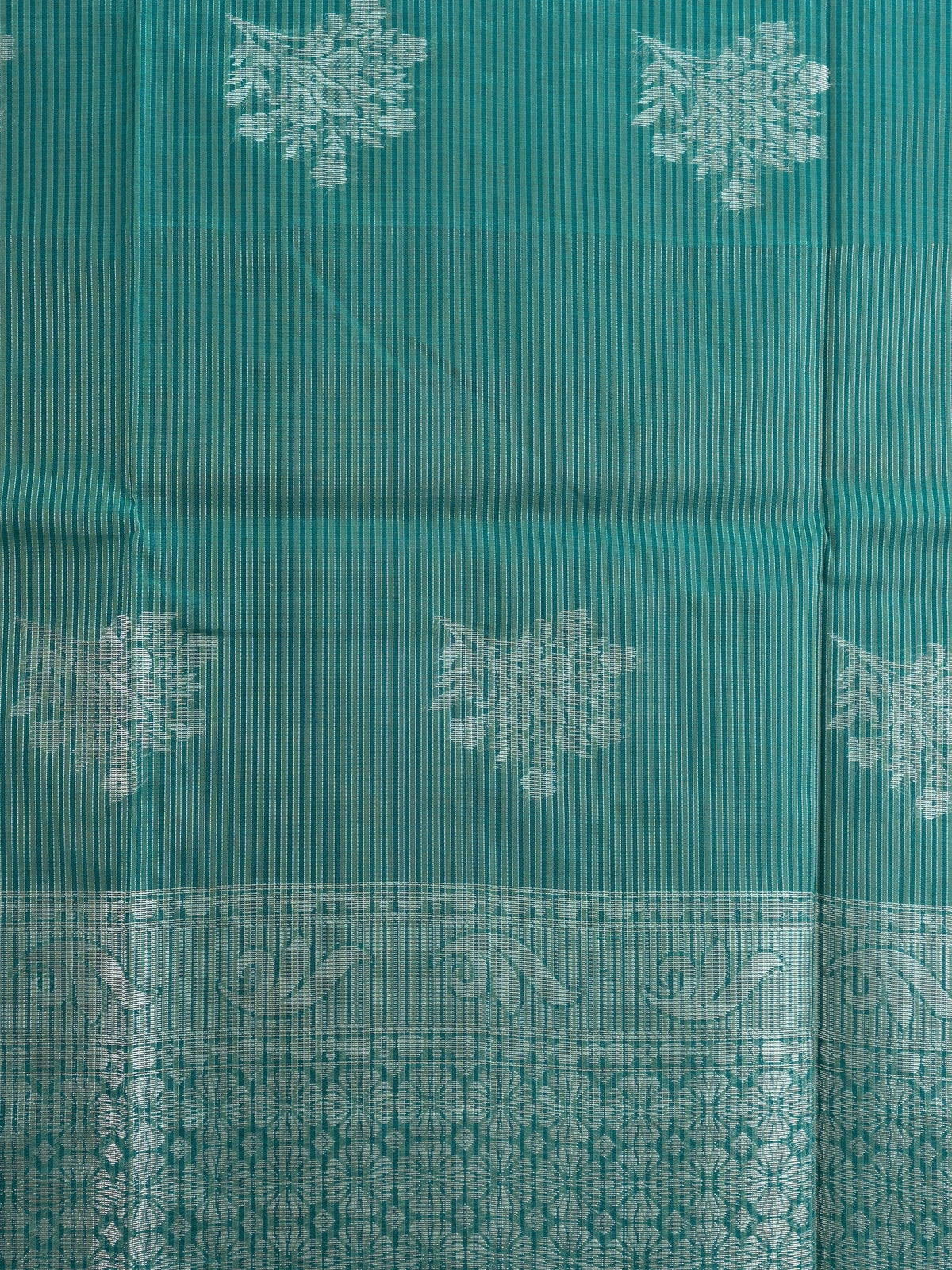 Teal green silk cotton saree with silver zari floral butta and ornate zari pallu