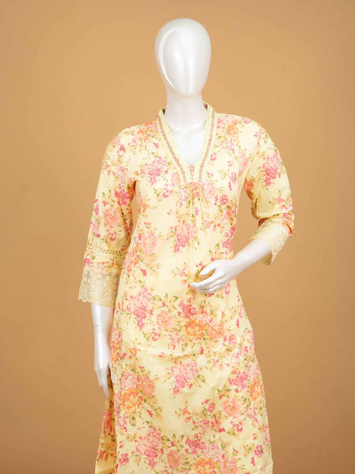 Yellow floral cotton Anarkali kurti set with beaded V-neck, lace cuffs, straight pants, and pink-bordered dupatta