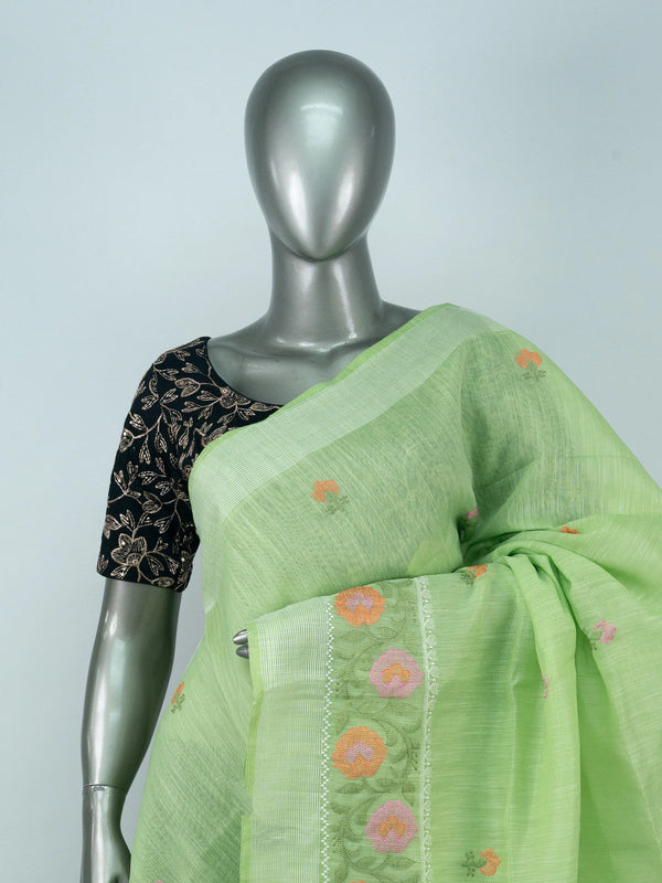 Light green linen cotton saree with silver zari border and multicoloured floral embroidery