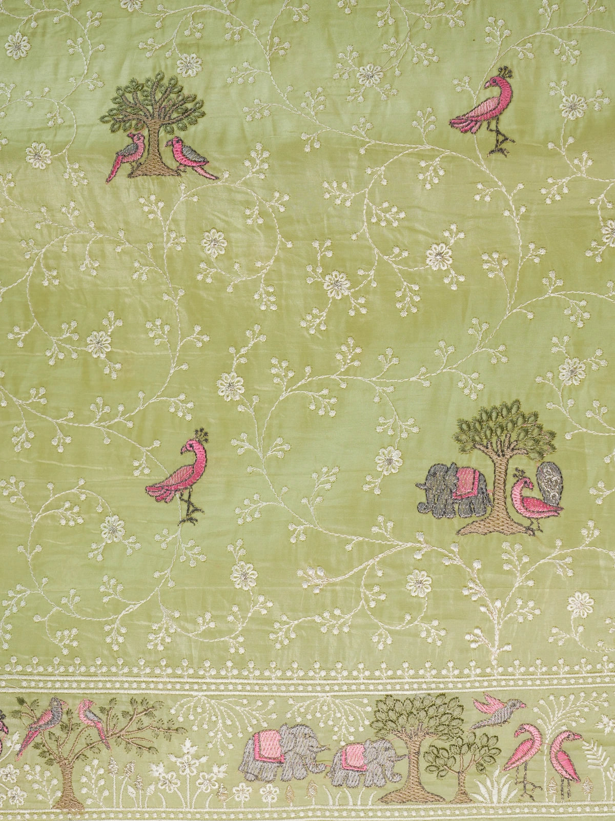 Lime green designer saree with white floral jaal, pink bird, tree and elephant embroidery and matching blouse