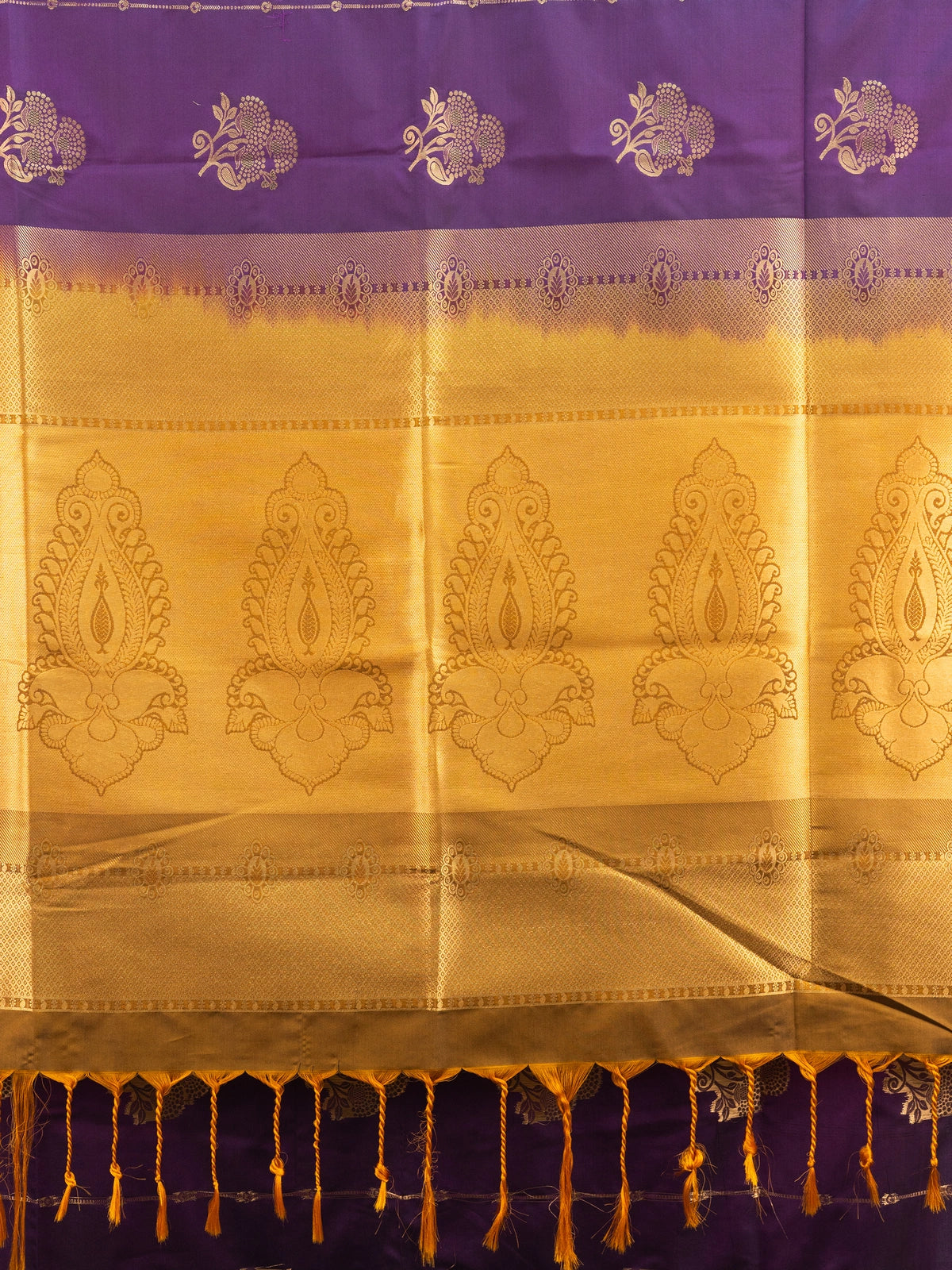 Purple Kanchipuram fancy silk saree with mustard-gold zari border, floral buttas and paisley pallu
