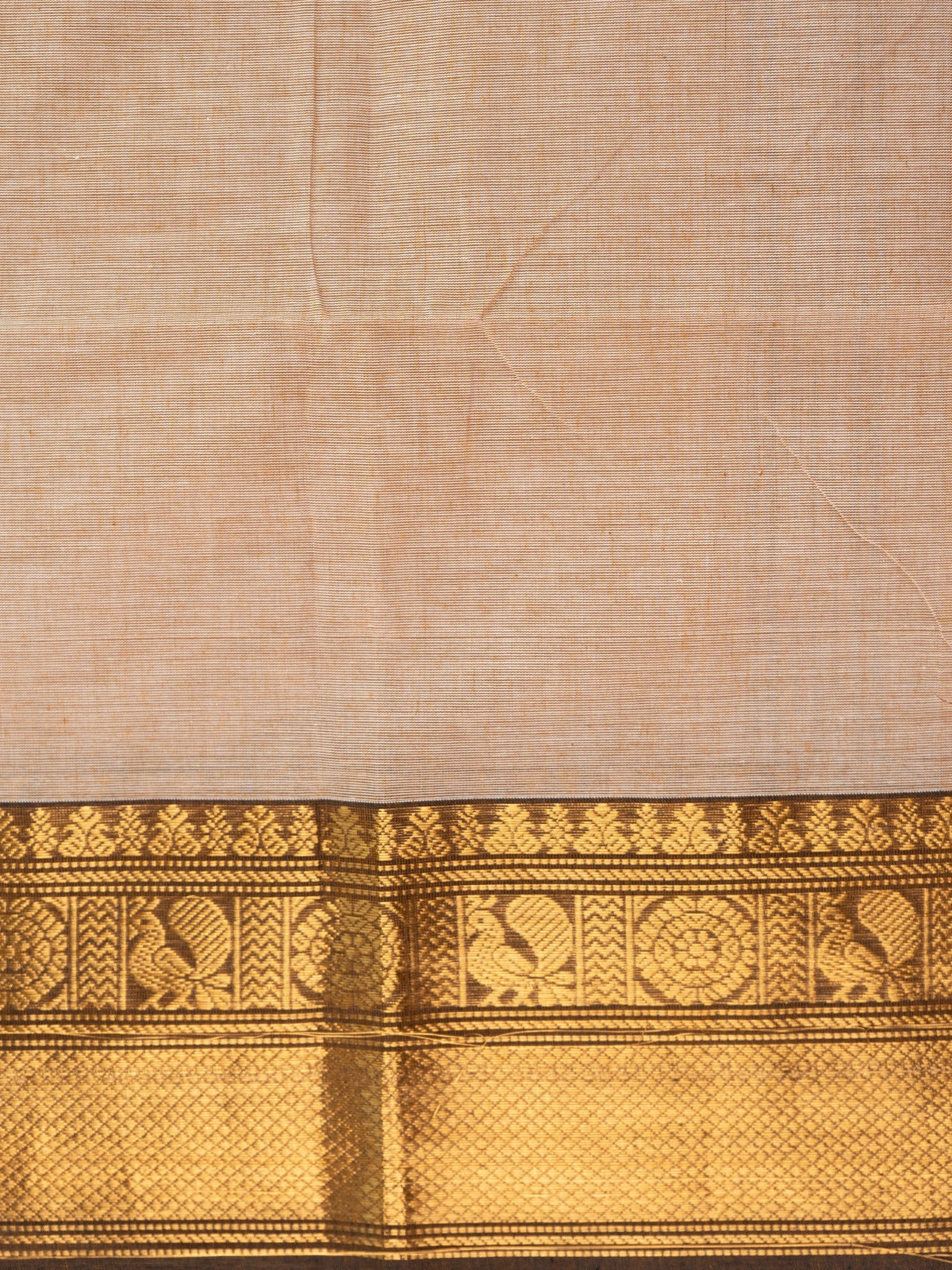 Beige Chettinad cotton saree with dark brown and gold zari peacock motif border