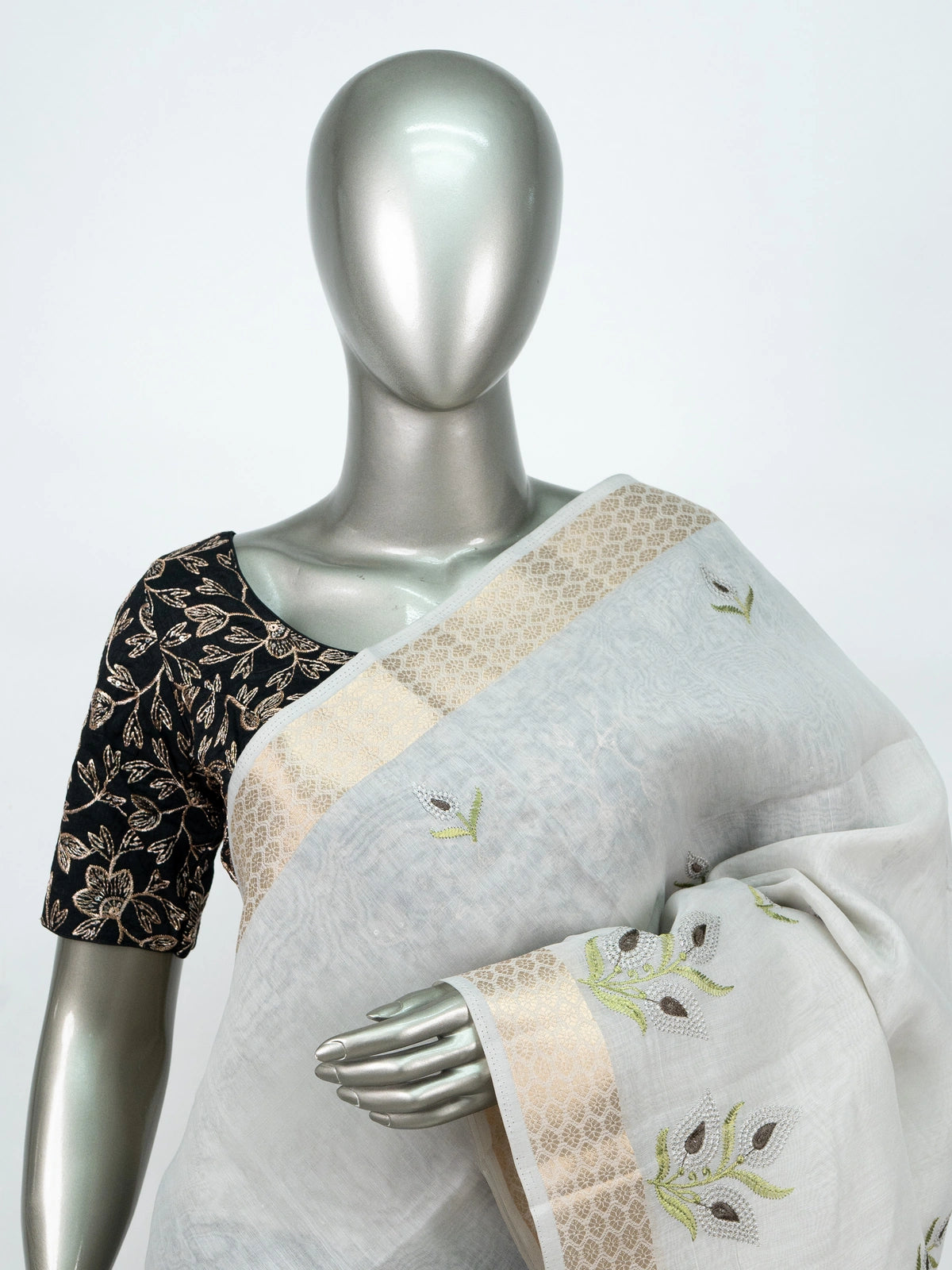 White linen cotton saree with gold zari border, embroidered leaf buttas and contrast black blouse