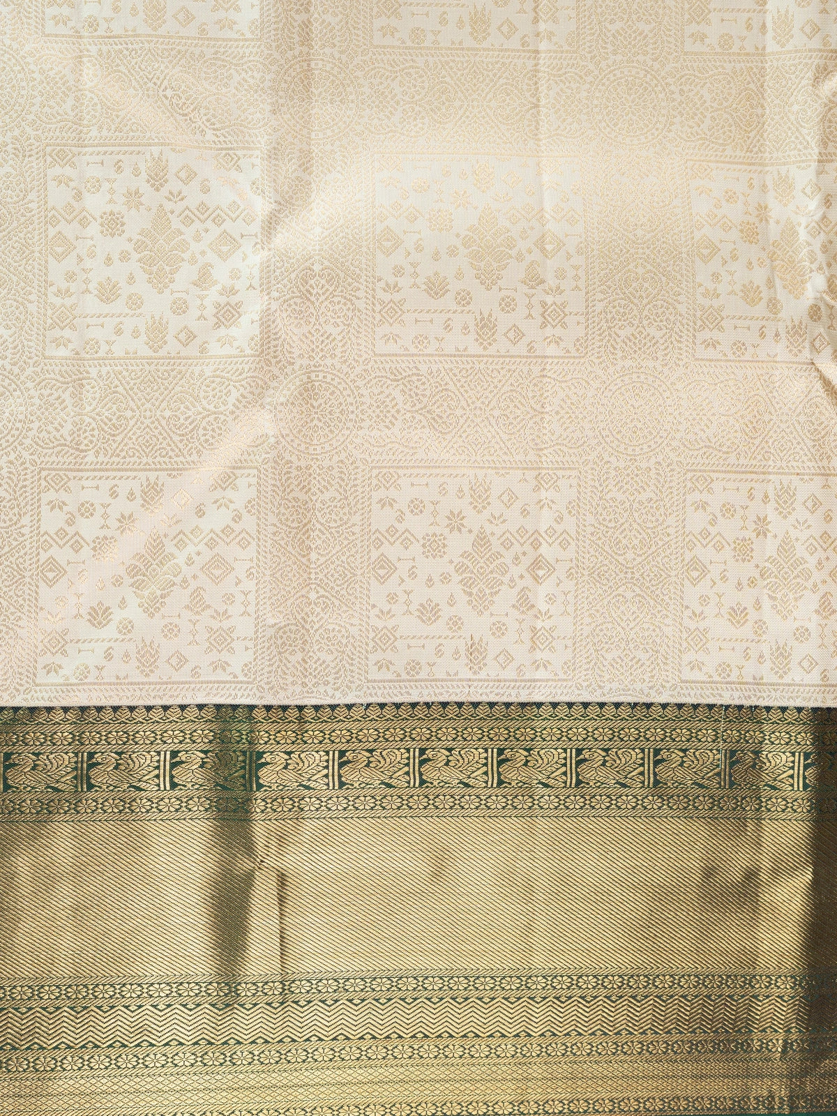 Cream pure Kanchipuram silk saree with gold zari brocade body and contrast dark green and gold border and pallu