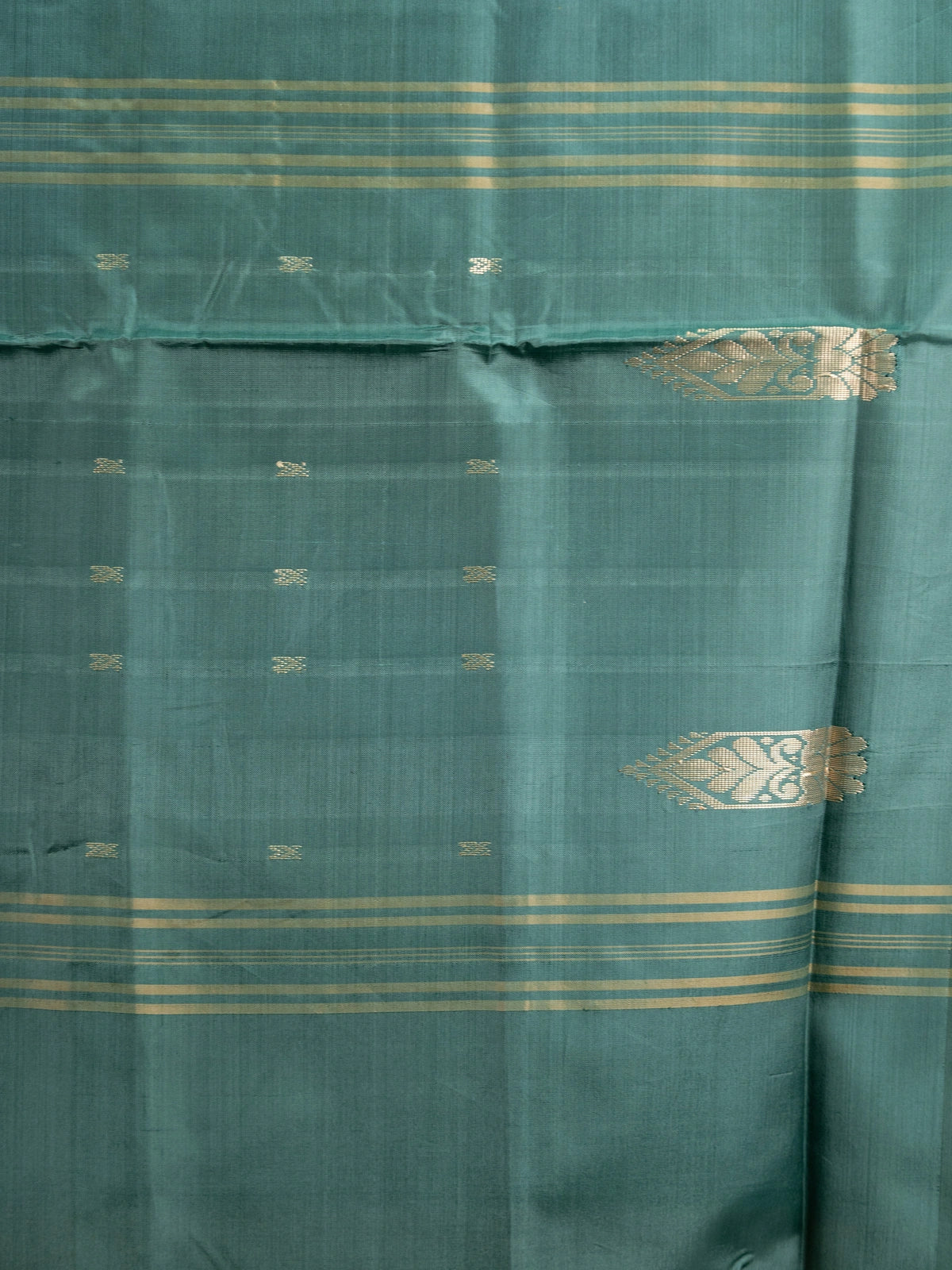 Mustard banana silk saree with contrast bottle-green border, gold zari buttas and striped tasselled pallu