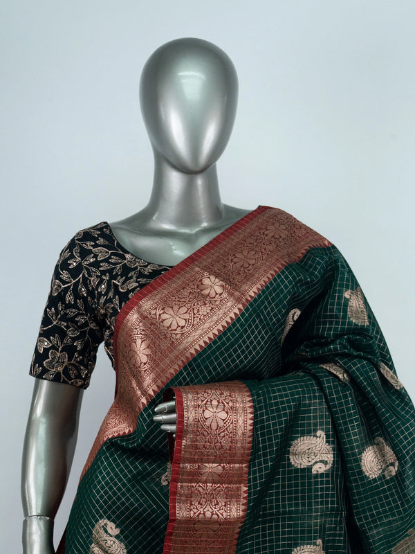 Dark green semi raw silk saree with red contrast zari border and paisley butta motifs
