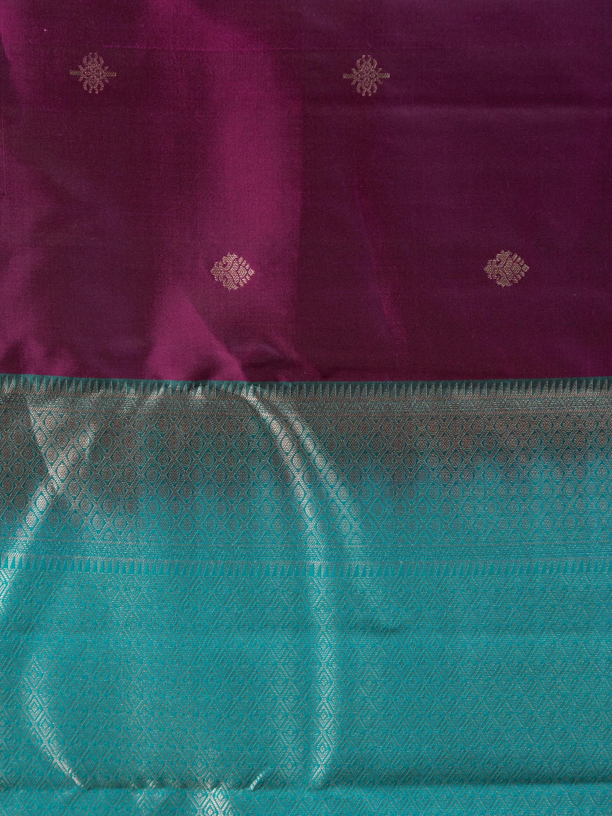 Purple pure Kanchipuram silk saree with teal contrast border and silver zari buti motifs