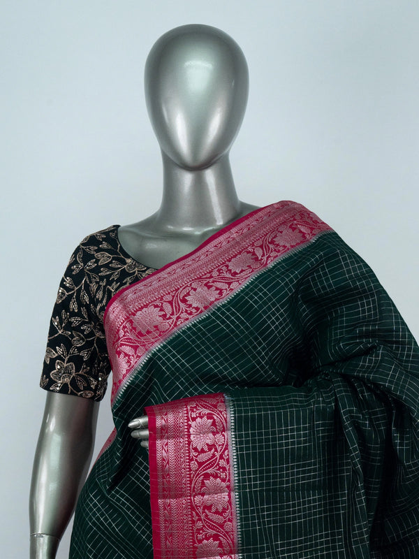 Bottle green semi raw silk saree with silver zari checks and contrast pink floral zari border