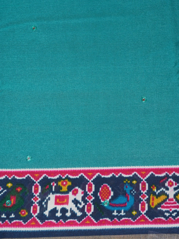 Teal linen cotton saree with navy and pink patola-style border, peacock and elephant motifs, and contrast blouse