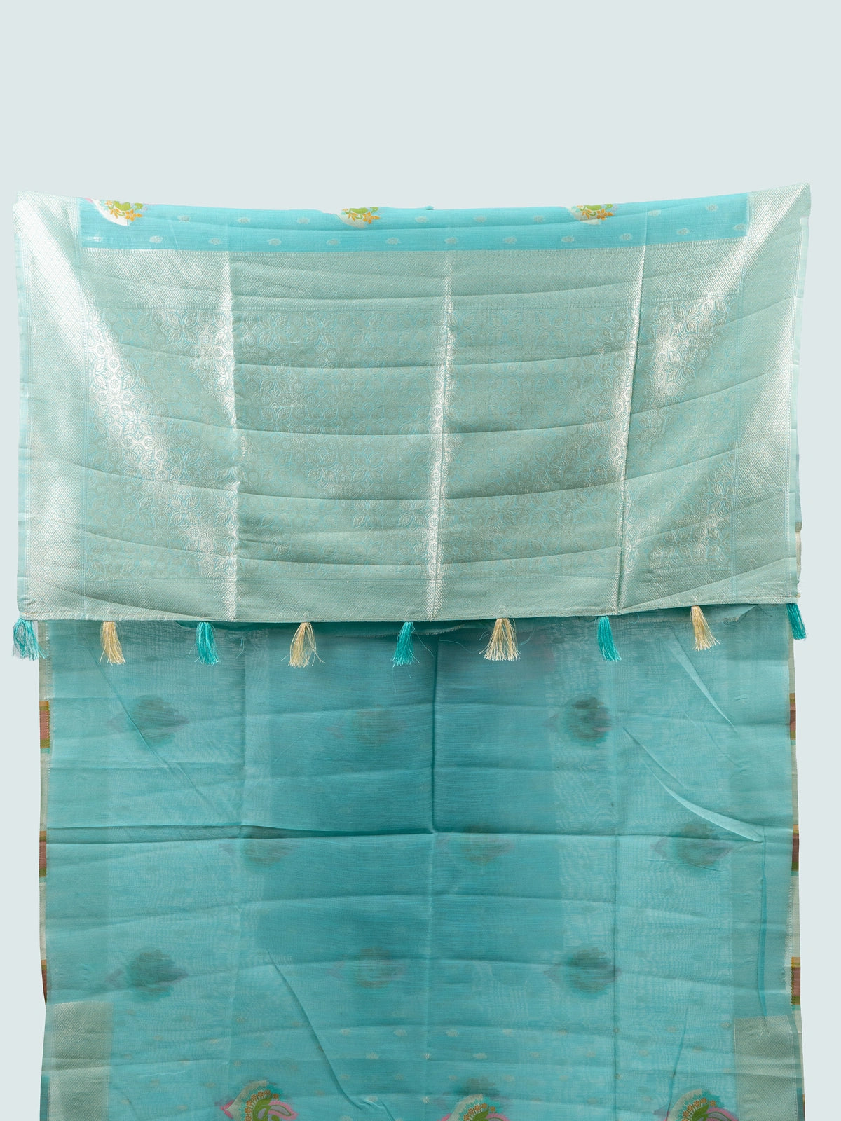 Aqua blue linen cotton saree with silver zari border, colourful peacock motifs and contrast black blouse