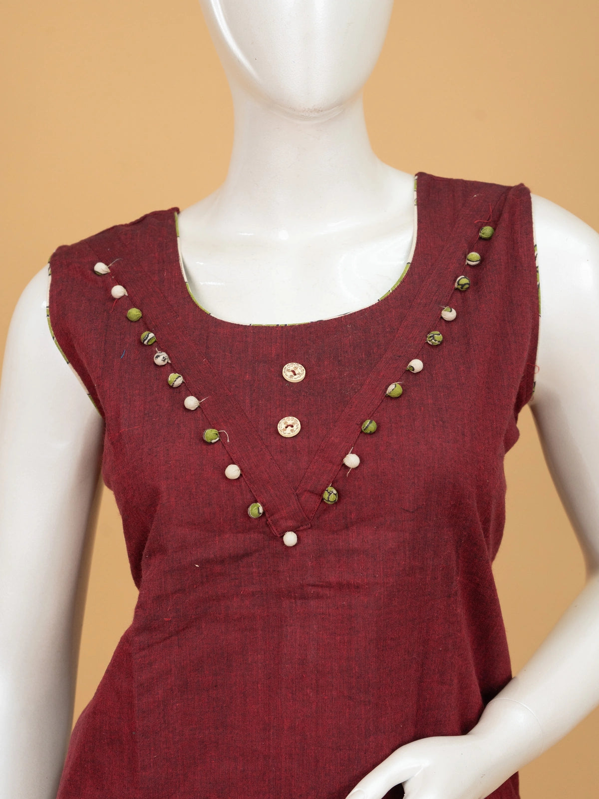Maroon cotton straight cut kurti set with pom-pom neckline, green kalamkari printed pants and contrast kalamkari dupatta