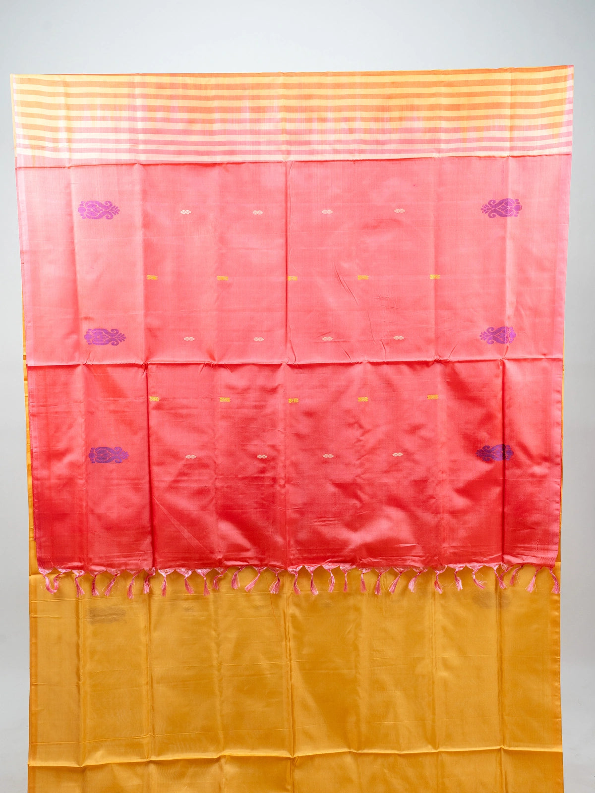 Mustard yellow banana silk saree with contrast pink pallu, purple paisley butis and gold zari work