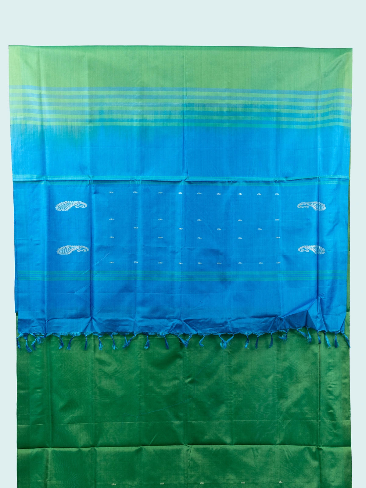 Green banana silk saree with contrast blue pallu, silver paisley motifs and striped border