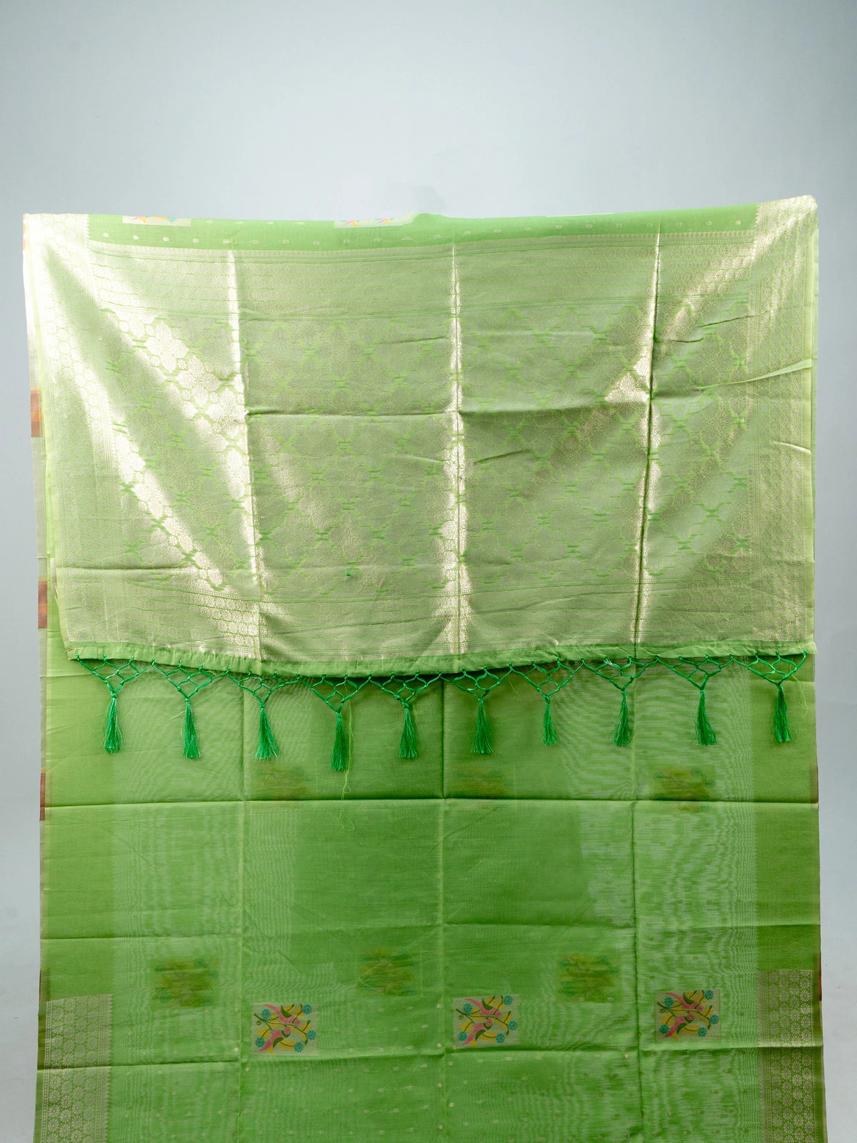 Pista green linen cotton saree with silver zari border and colourful floral buttas