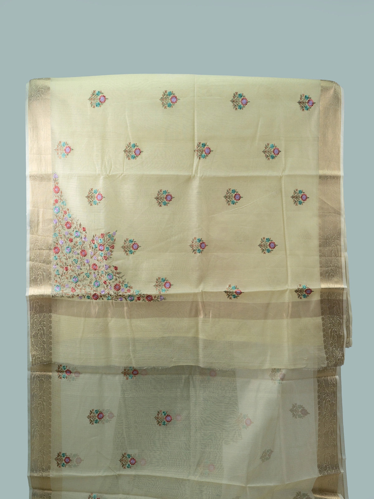 Cream linen cotton saree with gold zari border and multicoloured floral embroidered butas