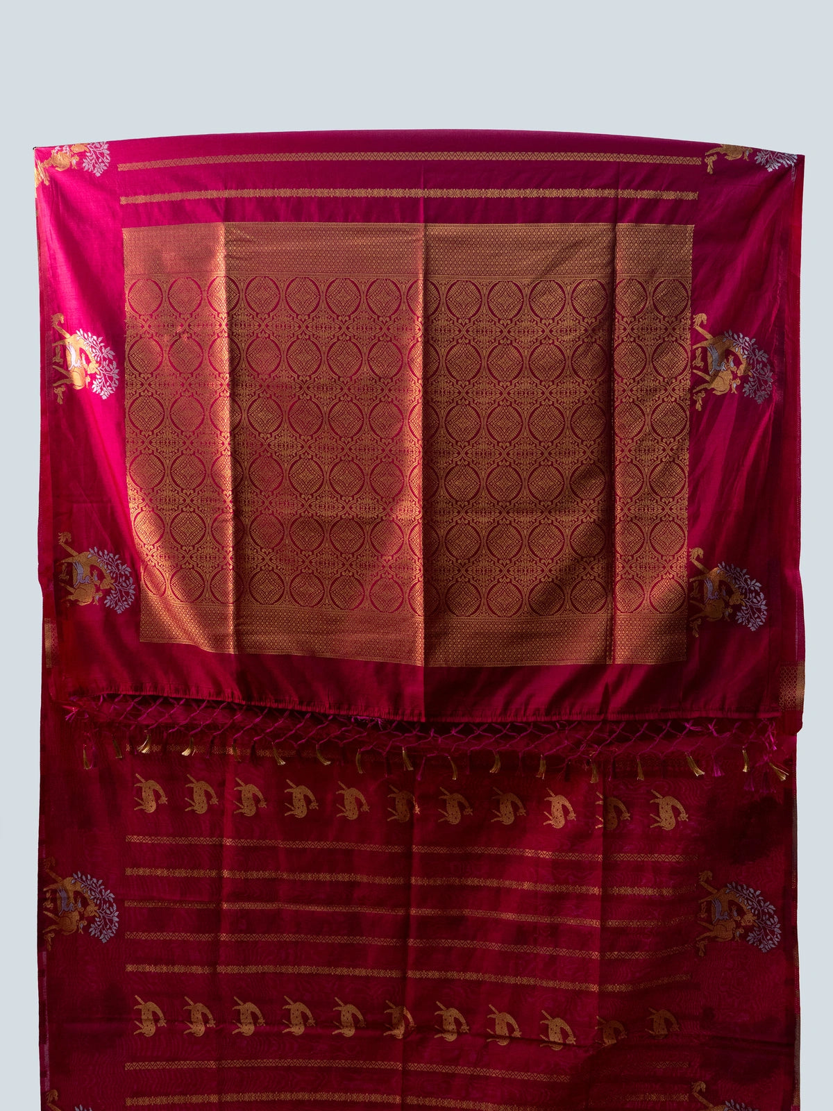 Rani pink semi raw silk saree with gold zari folk motifs, brocade pallu and contrast black blouse