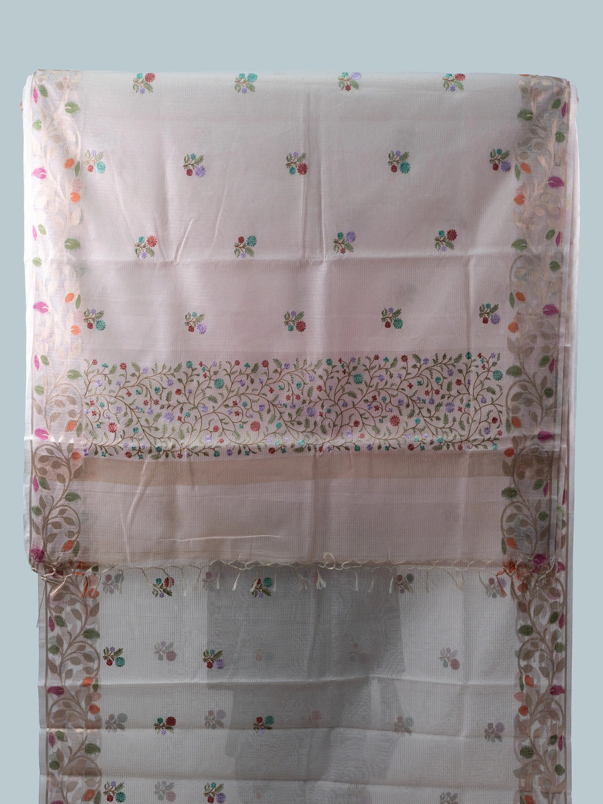 Blush pink linen cotton saree with multicolour floral buttas, gold zari floral border and contrast black embroidered blouse