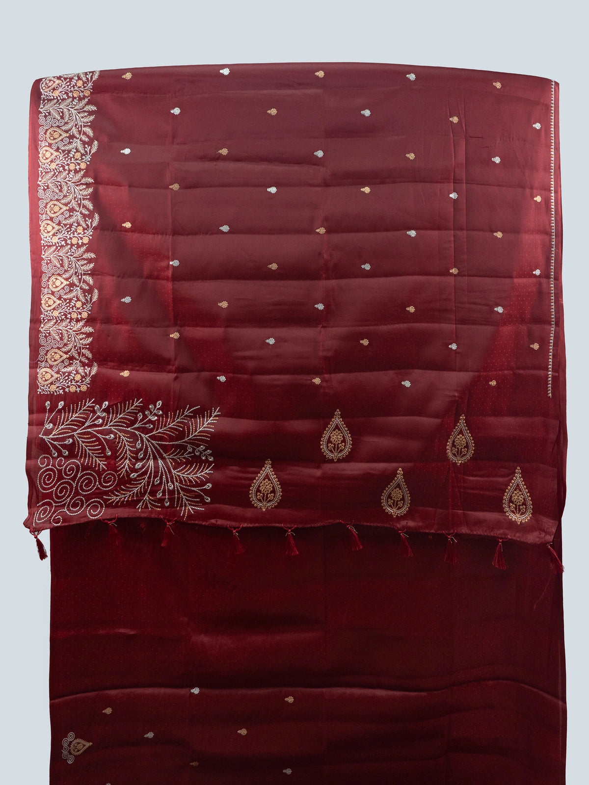 Maroon semi raw silk saree with embroidered pallu, buta motifs and contrast black embroidered blouse