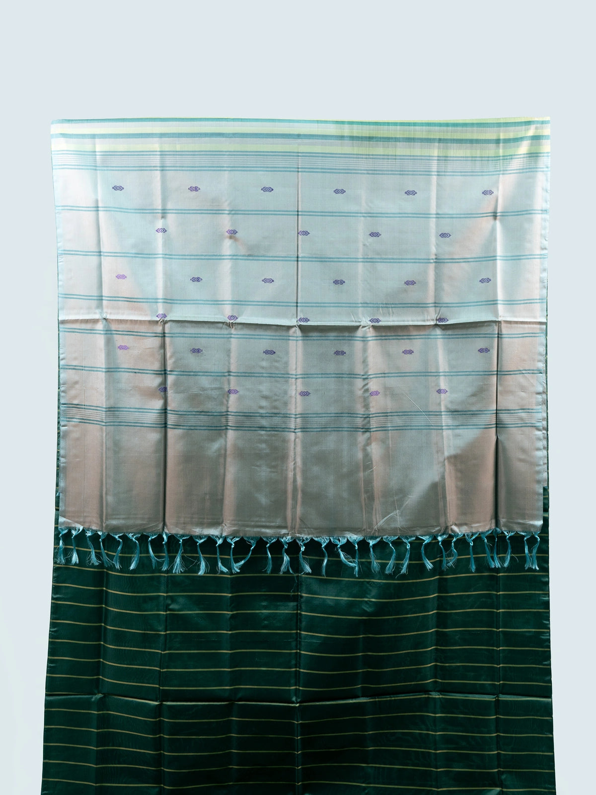 Bottle green banana silk saree with gold zari stripes, woven buti motifs and a contrast silver-grey tasselled pallu