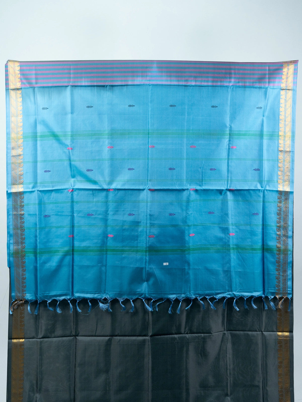 Grey silk saree with contrast blue pallu, gold zari border and black embroidered blouse