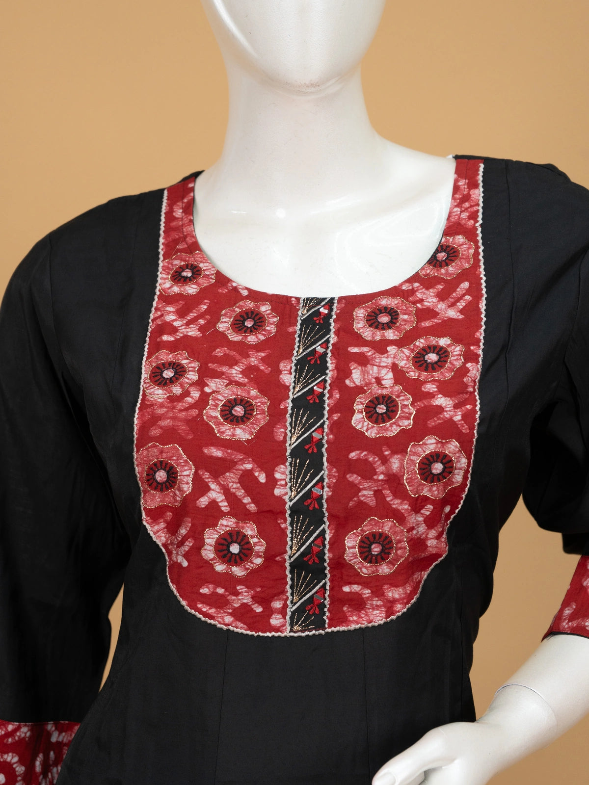 Black A-line cotton kurti set with red batik-print yoke and zari-bordered dupatta