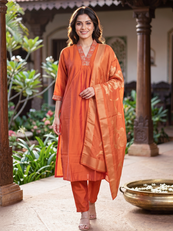 Orange art silk kurti set with embroidered V-neck and gold zari woven dupatta