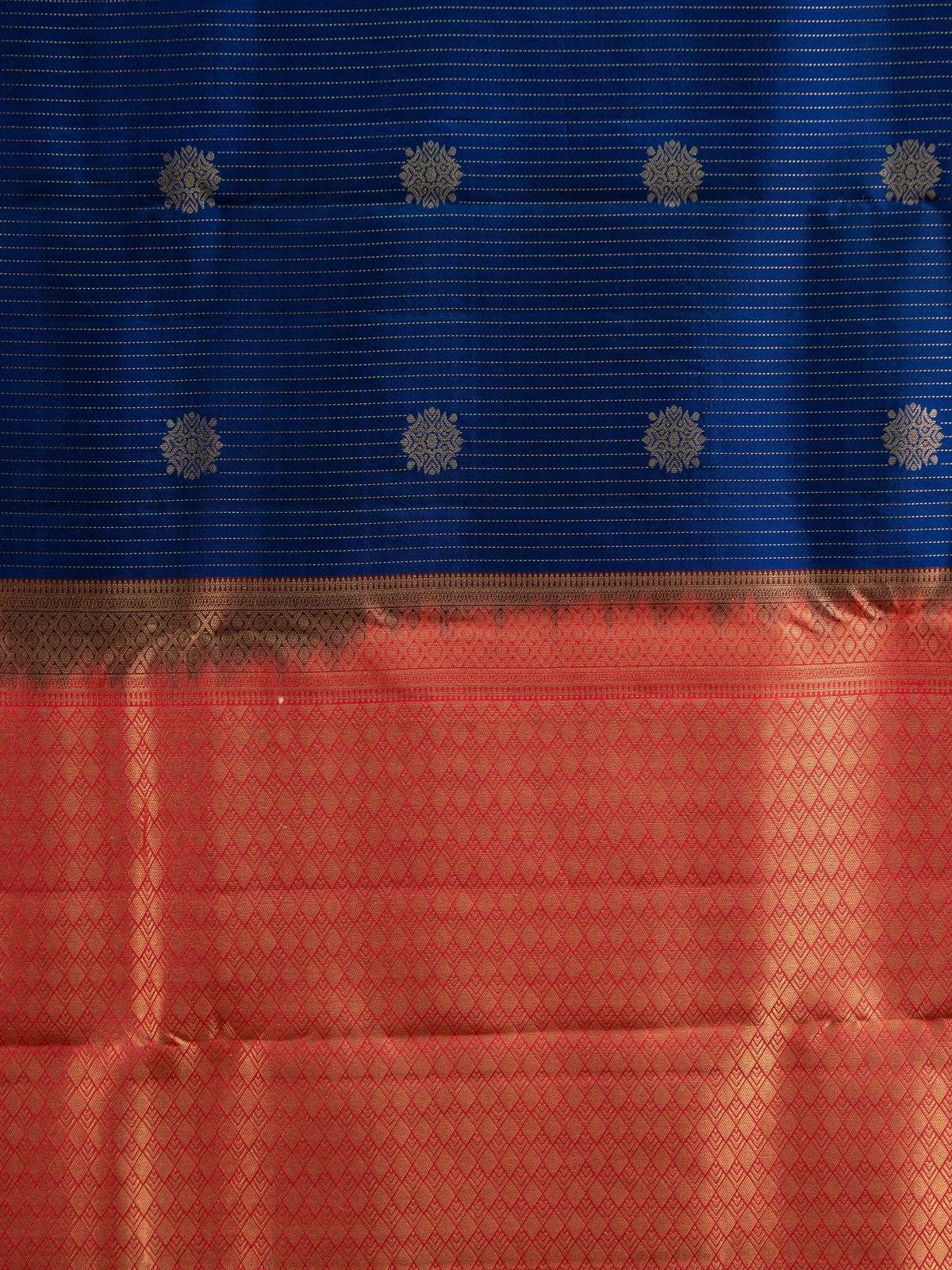 Navy blue pure Kanchipuram silk saree with gold zari stripes, floral buttas and contrast red gold zari border