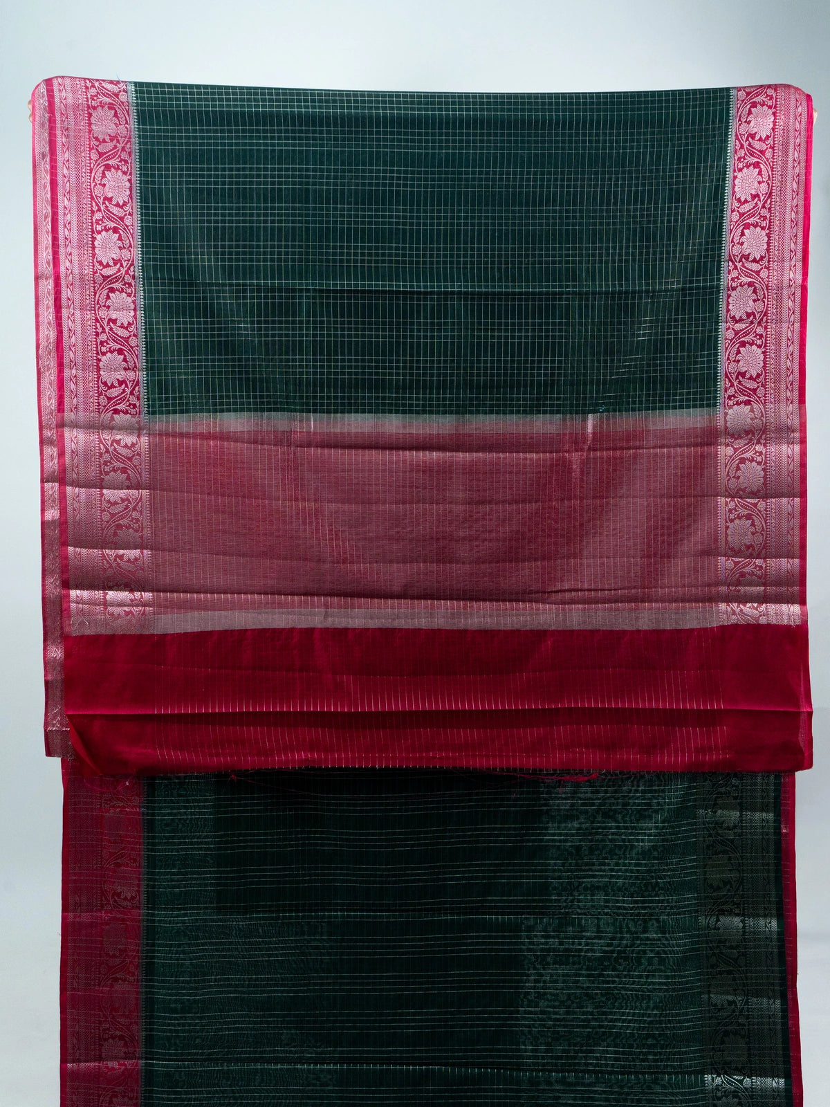 Bottle green semi raw silk saree with silver zari checks and contrast pink floral zari border