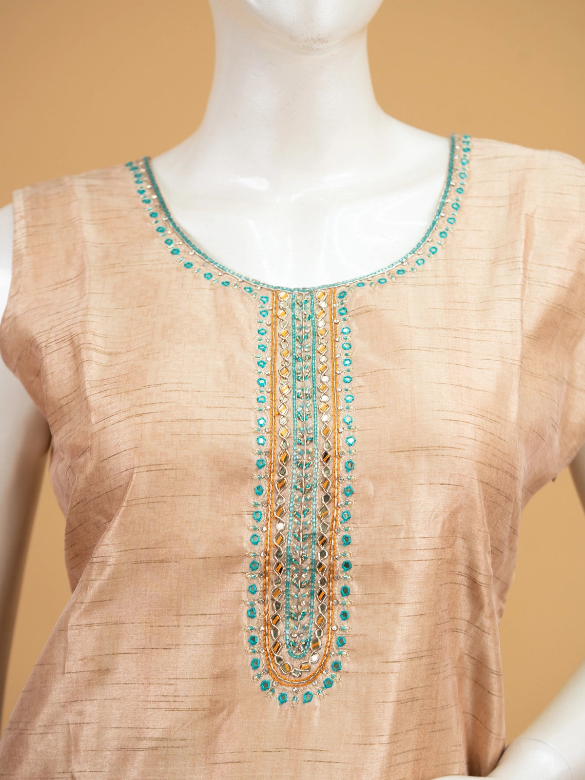 Beige floral raw silk straight cut kurti set with mirror work neckline, teal border and matching dupatta