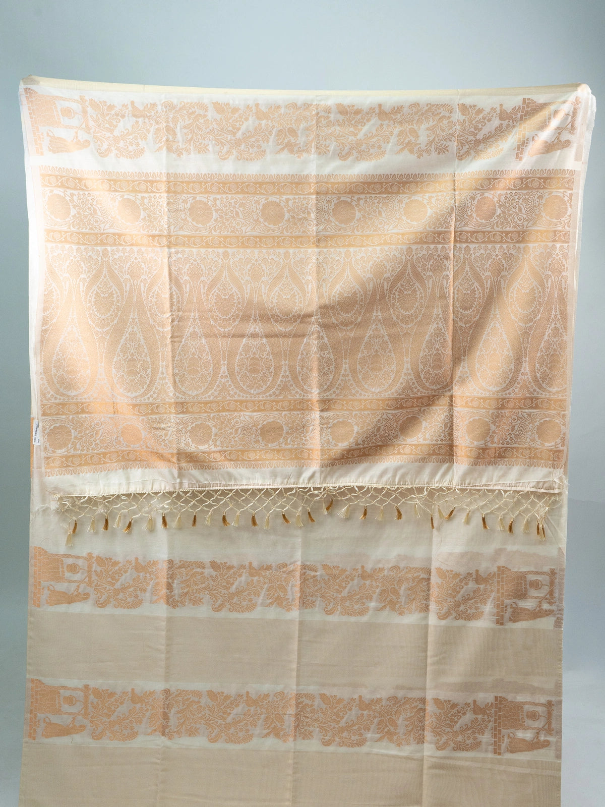 Cream semi raw silk saree with copper woven paisley and floral motifs and a contrasting embroidered black blouse