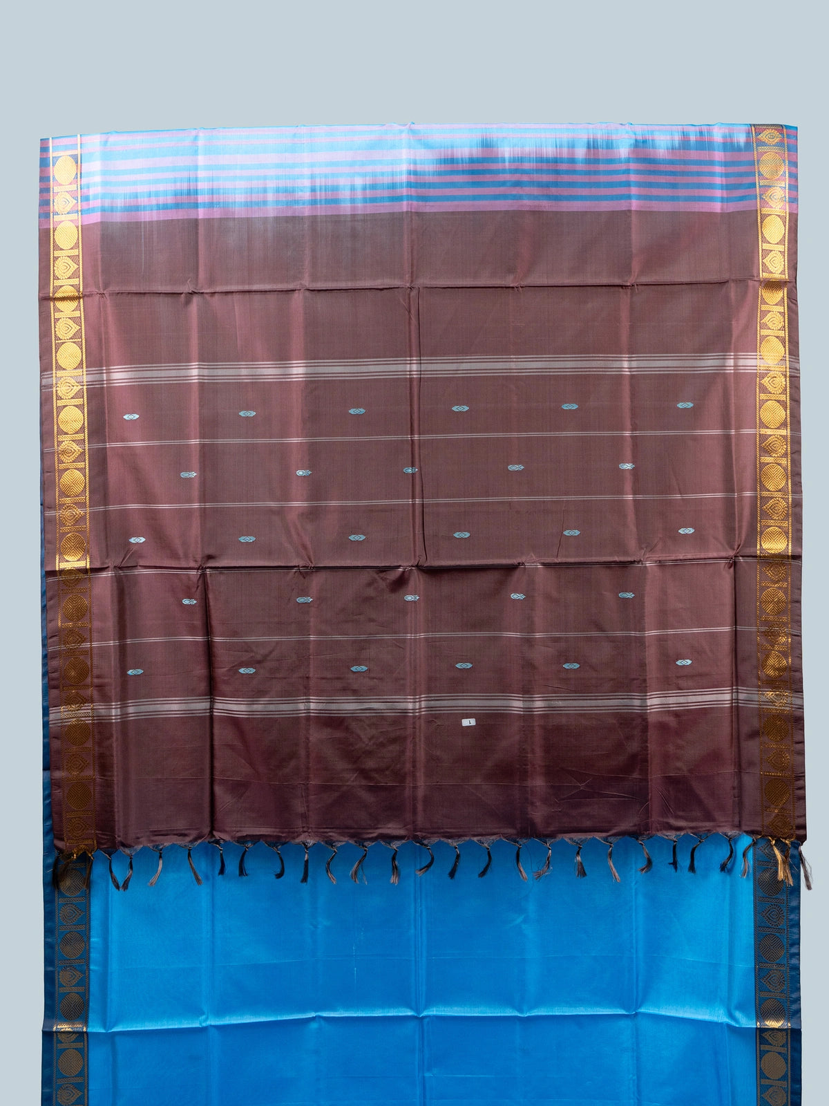 Sky blue banana silk saree with contrast brown pallu and gold zari border