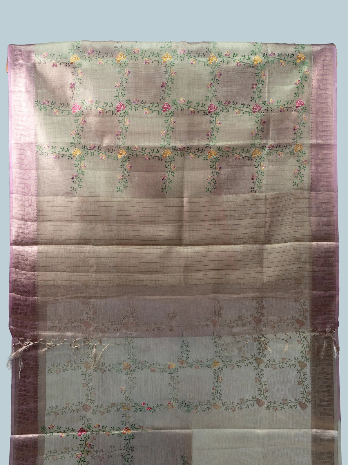 Beige linen cotton saree with mauve pink zari border, multicoloured floral embroidery and a black contrast blouse