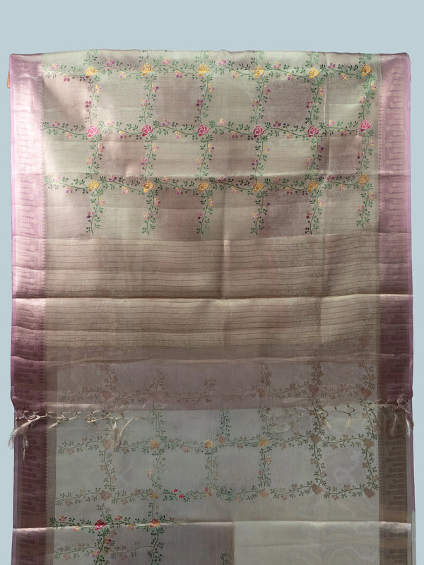 Beige linen cotton saree with mauve pink zari border, multicoloured floral embroidery and a black contrast blouse