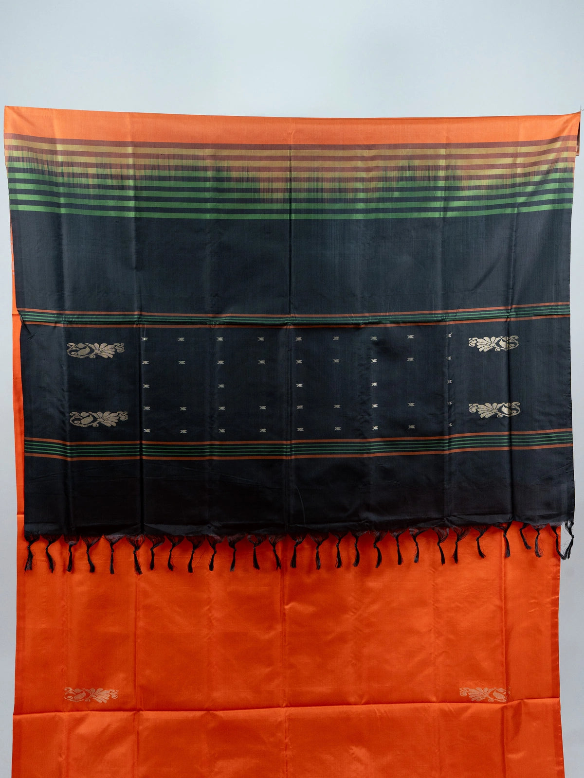 Orange Banana Silk saree with contrast black striped pallu, gold zari buttas and embroidered black blouse