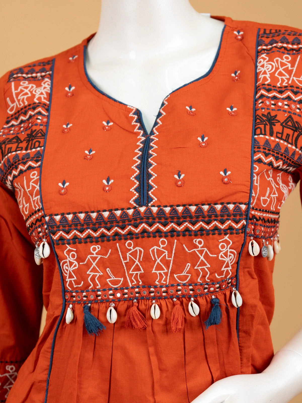 Rust orange cotton Warli embroidered Anarkali kurti set with cowrie shell tassels and matching dupatta