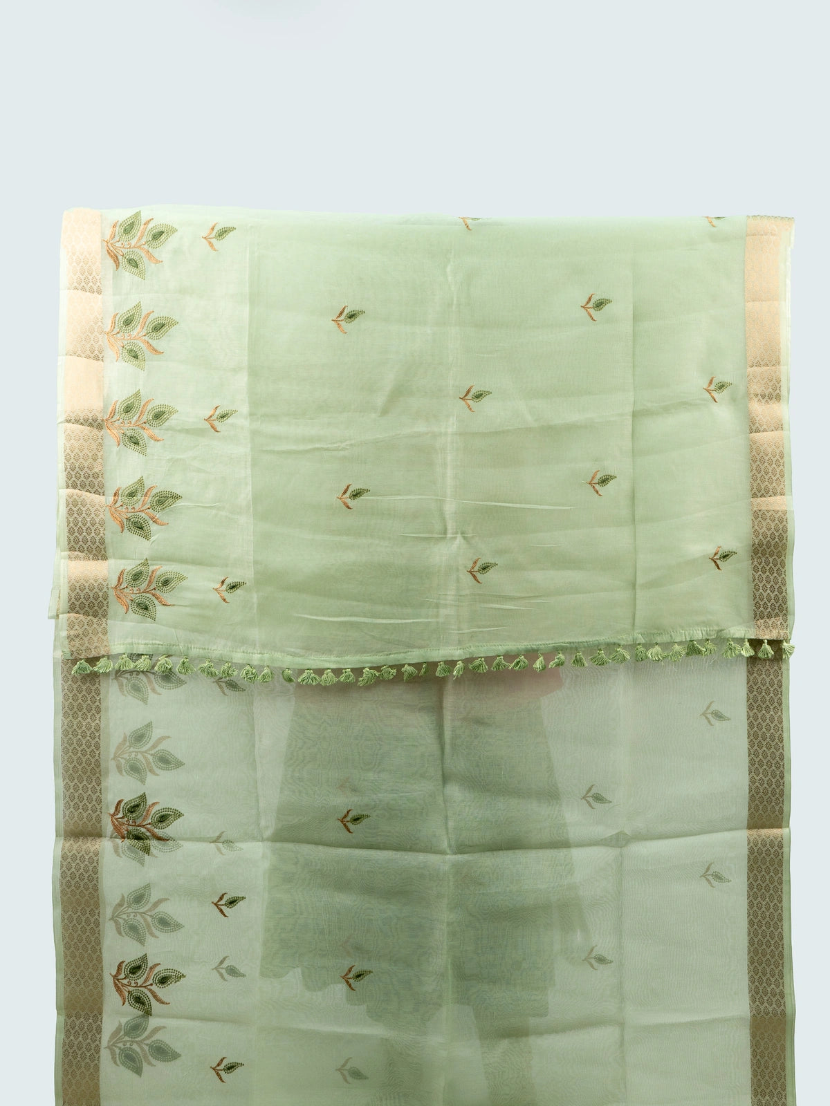 Pista green linen cotton saree with gold zari border, embroidered leaf buttas and contrast black embroidered blouse